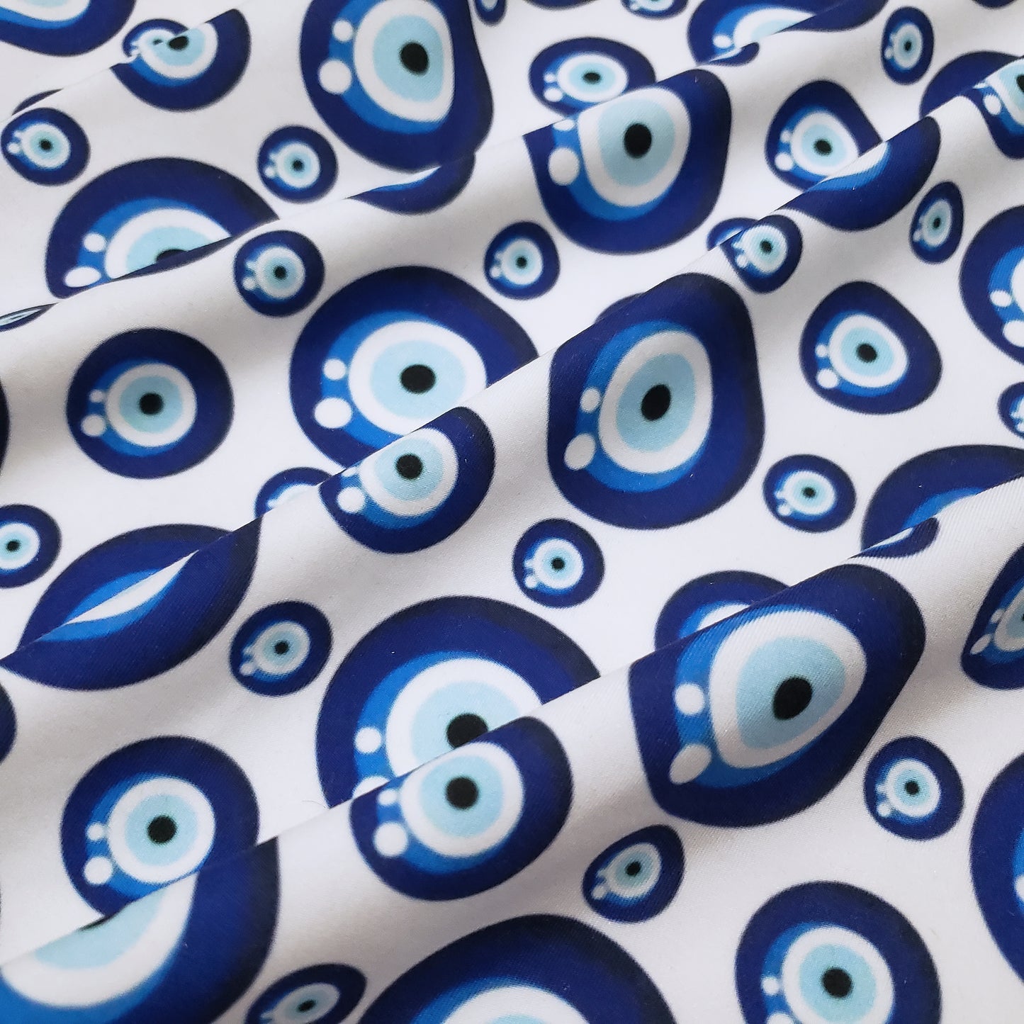 Evil Eye Nazar Print Fabric – Navy, Royal & Light Blue Eyes on White 4-way Stretch Poly Spandex